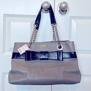 Grey Kate Spade purse with large bow detail on front